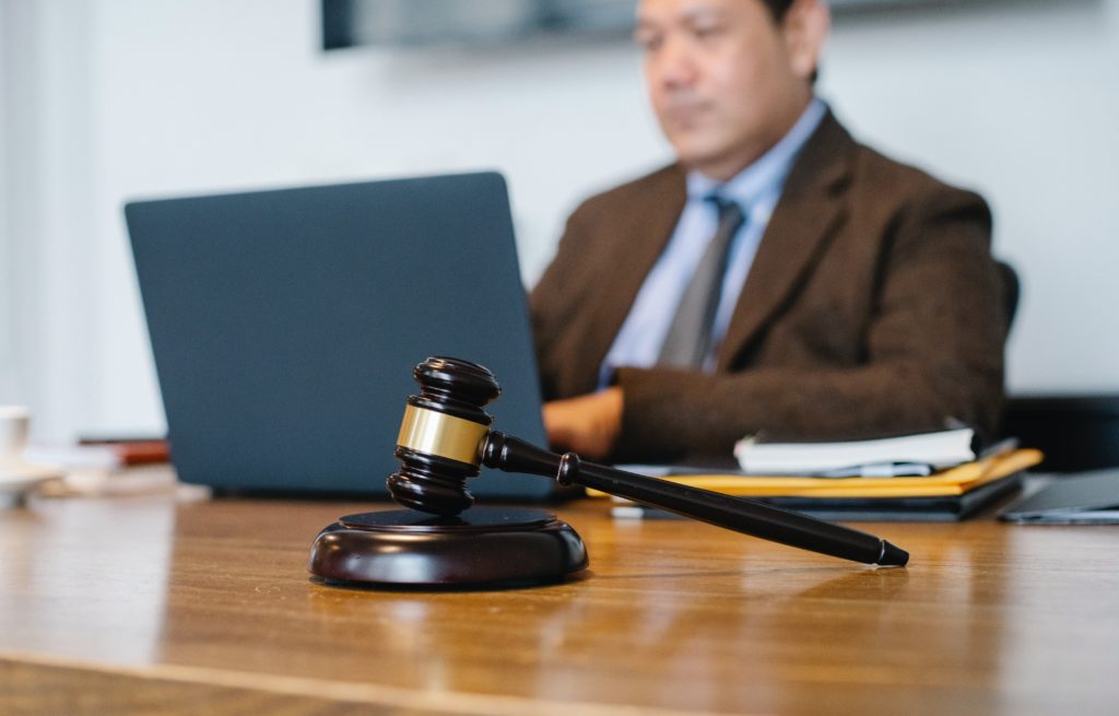 man sitting behind computer desk at law firm
