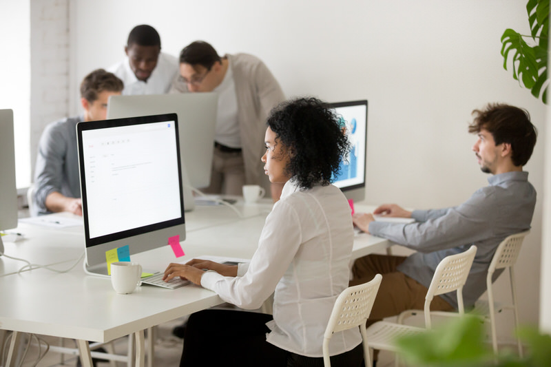 A group of young professionals working together in an office setting